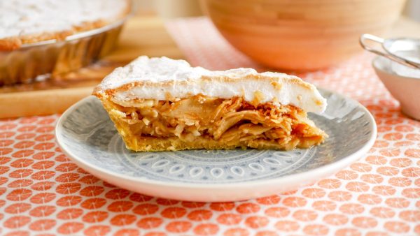 Egy szelet habos almás pite tányéron, vastag tojáshab réteggel